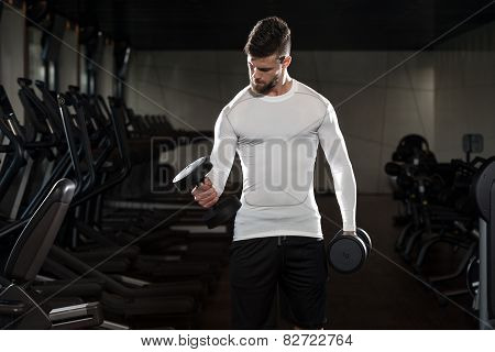 Young Male Doing Biceps Exercises In The Gym