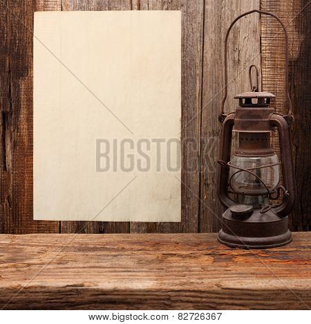 lamp oil lantern paper blank old wooden background
