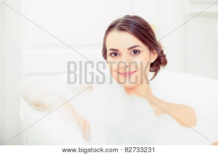 Beautiful young woman taking a bath