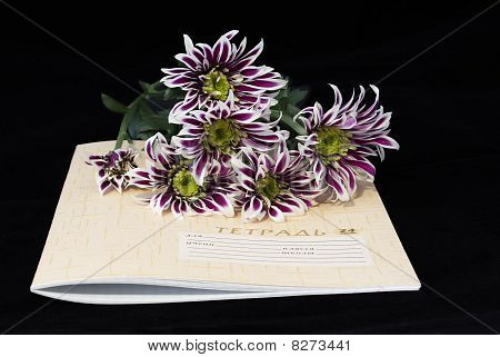 Closed Notebook And Flowers