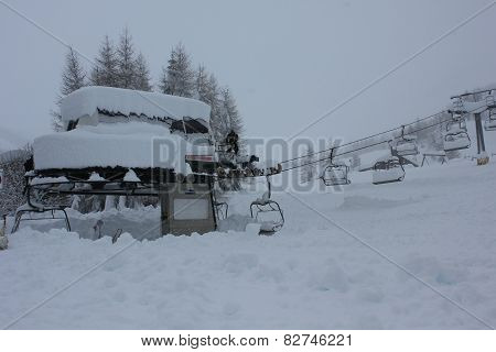 Chair Lift in a snowy foggy day.