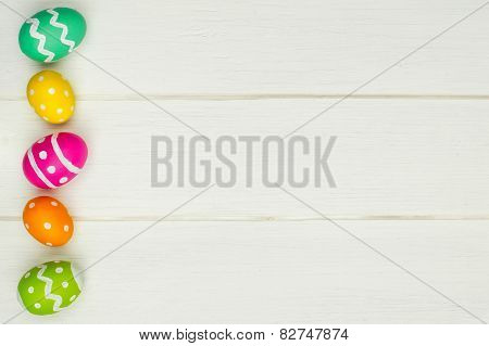 Easter egg side border against white wood