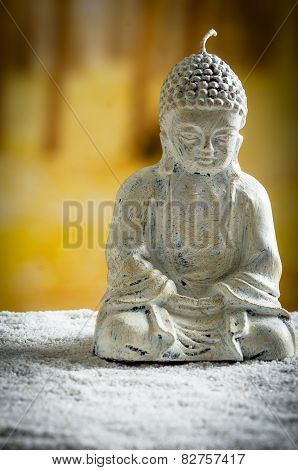 small sculpture of buddha over white pebbles