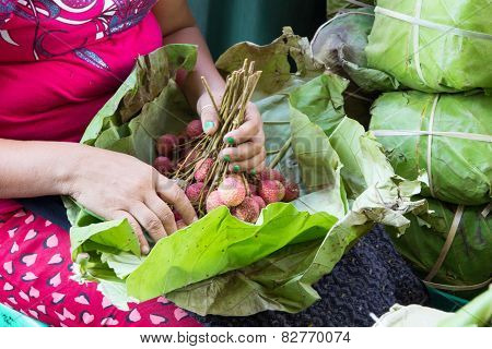 Woman Unwrapping Fruit