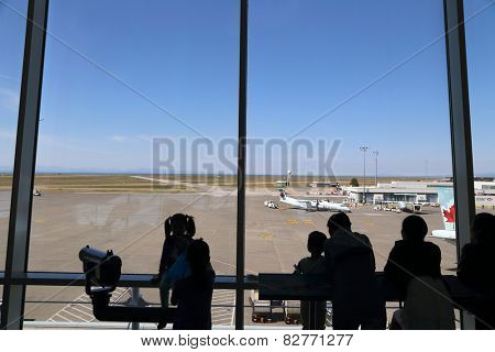 Vancouver, BC Canada - September 13, 2014 : People inside YVR airport watching air canada airplane in Vancouver BC Canada. 