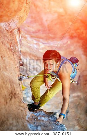 Rock climber climbing up a cliff