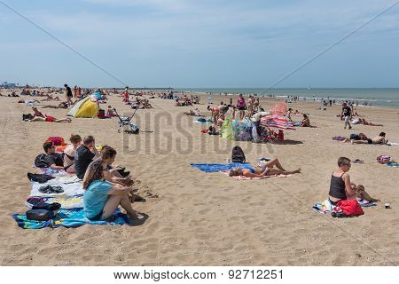 Seaside Visitors Relaxing At Dutch Beach Of Scheveningen