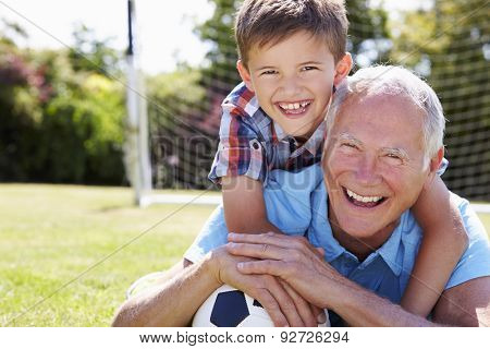 Portrait Of Grandfather And Grandson With Football