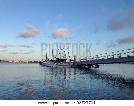 Sailboats Docked In Bay