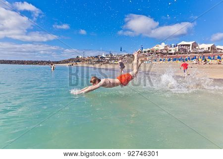 Boy Has Fun In The Clear Sea