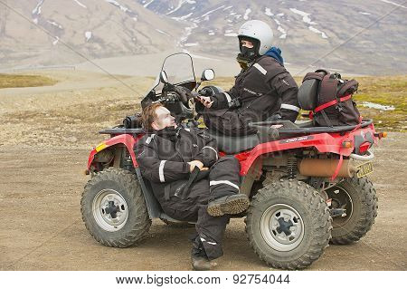 People enjoy off-road vehicle excursion in Longyearbyen, Norway.