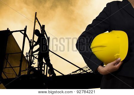 Engineer Holding Yellow Helmet