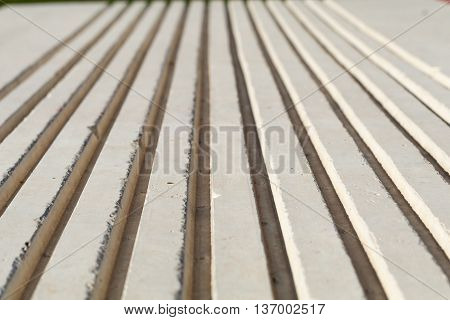close of of concrete bench showing ridges shot with shallow field of focus