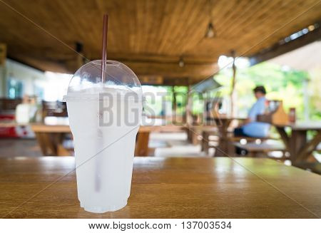 Lemon Soda Iced cold in plastic glass in wooden cafe.