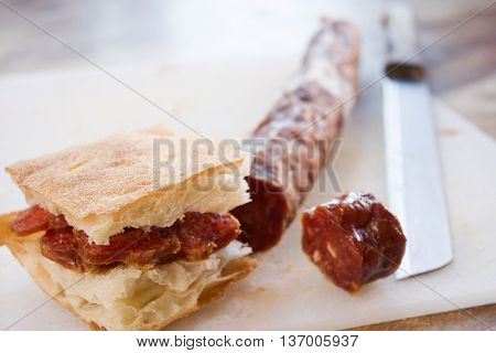 white pizza or bread focaccia stuffed with slices of salami
