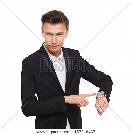 Time is money. Businessman point finger at his watch showing that it is late, hurry up, check the time. Man in suit isolated at white background.