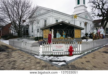 PLAINFIELD, ILLINOIS / UNITED STATES -DECEMBER 29, 2015: A nativity scene, presented by the Plainfield Lions Club, stands outside the Plymouth Congregational Church in downtown Plainfield.