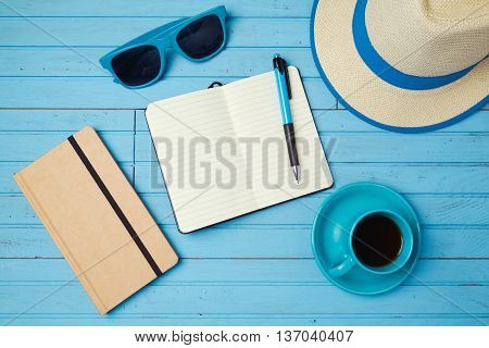 Summer holiday background with notebook and coffee cup. Vacation planning concept. Top view