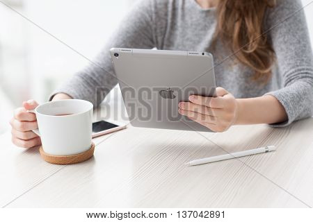Alushta Russia - May 29 2016: Woman holding in the hand a new iPad Pro Space Gray. iPad Pro was created and developed by the Apple inc.