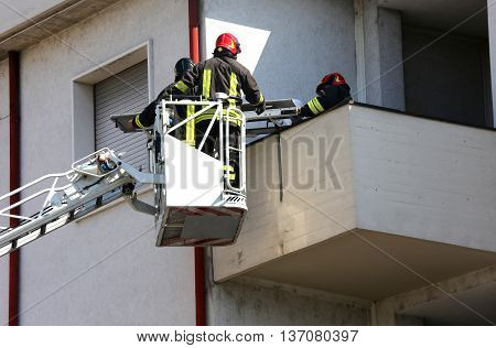 Two Firefighters In The Elevated Cage Of Fire Engine