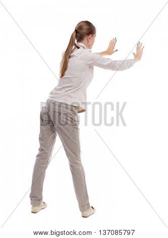 back view of woman pushes wall. Isolated over white background. Rear view people collection. backside view of person. Girl with long hair in a white jacket pushes away something left.