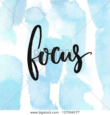 Focus. Calligraphy word at blue watercolor strokes background. Phrase about work and concentration
