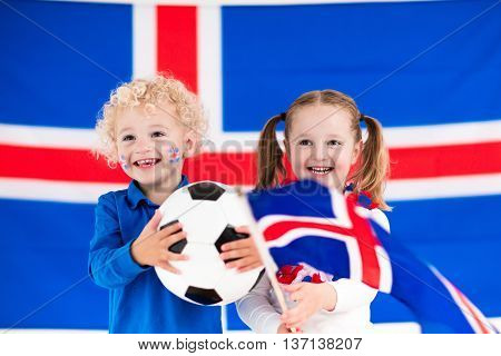 Children cheering and supporting Icelandic national football team. Kids fans and supporters of Iceland during soccer championship.