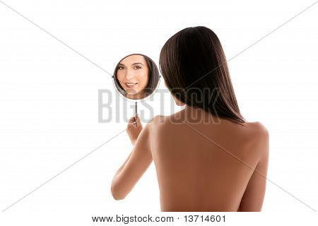 A Beauty Image Of A Young Woman Looking Into A Mirror, Smiling.