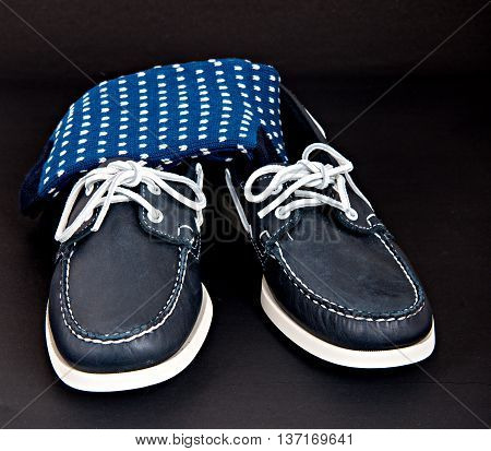 Blue Docksides deck shoes with hand-linked toes socks isolated on black