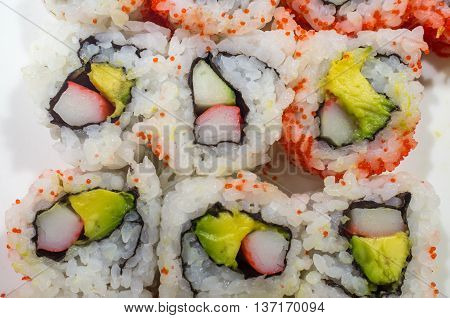 Top view of California roll sushi with red fish roe