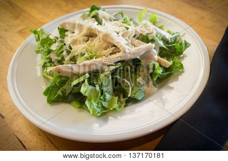 Fresh organic caesar salad with grated asiago cheese