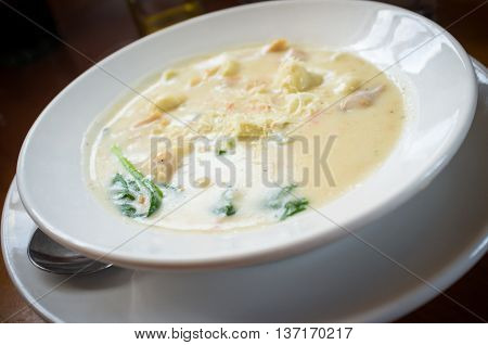 Creamy chicken gnocchi traditional Italian soup with bread and oilve oil
