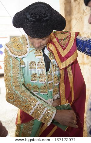 Ubeda SPAIN - September 29 2010: Spainish bullfighter Manuel Jesus EL Cid putting itself the walk cape in the alley before going out to bullfight typical and very ancient tradition in Ubeda Jaen province Spain