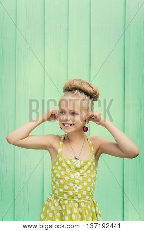 Beautiful girl holding cherries as earrings -style Rockabilly. Space for text