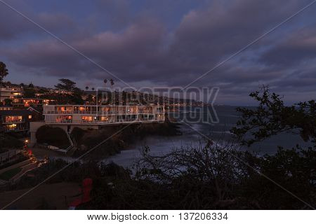 Dark clouds over Diver's Cove in Laguna Beach at sunset in the summer.