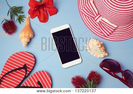 Smartphone mock up template with summer beach items and tropical flowers. View from above. Flat lay