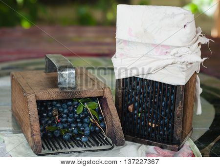 wooden tools are used to gather blueberries a scattering of fresh forest berries