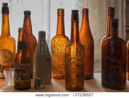 BODIE, CA, USA - OCTOBER 10, 2015: Vintage empty liquor bottles in Bodie State Park, California