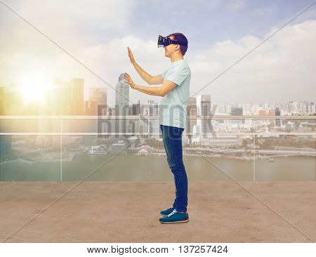 3d technology, virtual reality, entertainment, cyberspace and people concept - man with virtual reality headset or 3d glasses playing game and touching something over singapore skyscrapers background