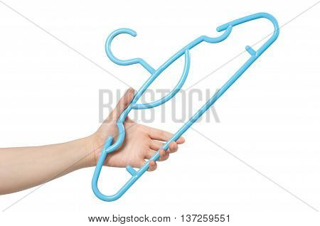 hand holding blue clothes hanger on white background.