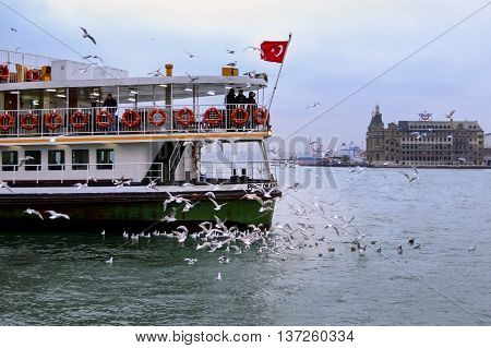 Istanbul Turkey - February 21 2013: Istanbul Strait ferry and seagulls. Gulls to feed the passion of ferry passengers.