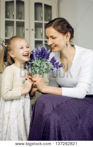 young mother with daughter at luxury home interior vintage, old fashion relashionship family