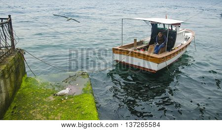 Istanbul Turkey - March 28 2015: Istanbul Bosphorus views And Uskudar Kuzguncuk coast a man resting on the boat. 