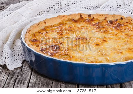 French onion quiche or pie in a gratin dish traditional recipe view from above