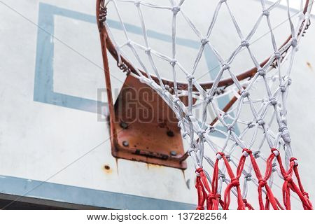 Close up basketball hoop net with drity old board