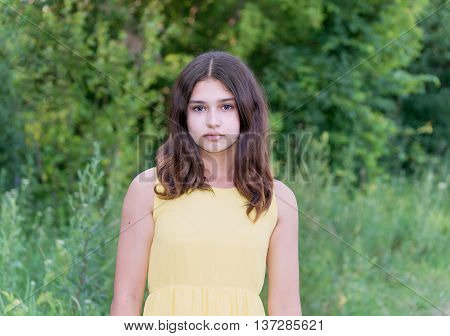 beautiful girl 14 years old posing on the nature of the summer