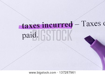Taxes Incurred Word Highlighted