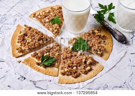 Traditional Asian thin tortilla with minced meat and pine nuts. Selective focus.