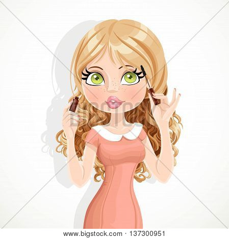Cute blond girl in pink dress colors eyelashes mascara isolated on a white background