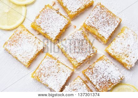 Dessert lemon bars over baking paper top view